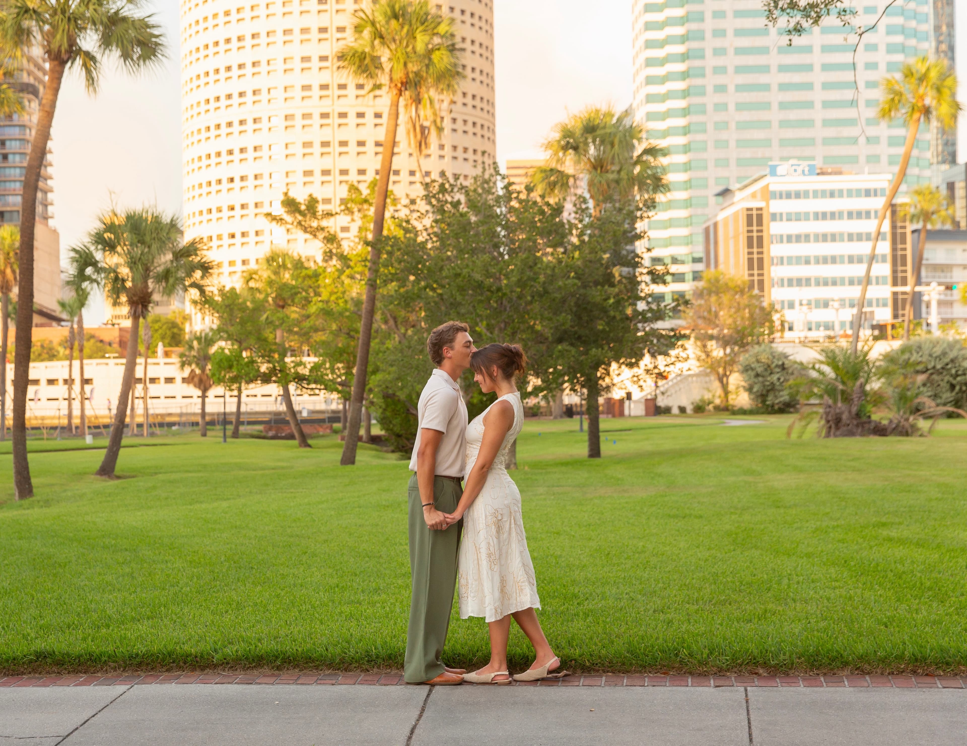 Trey and Annika on the lawn, downtown behind them
